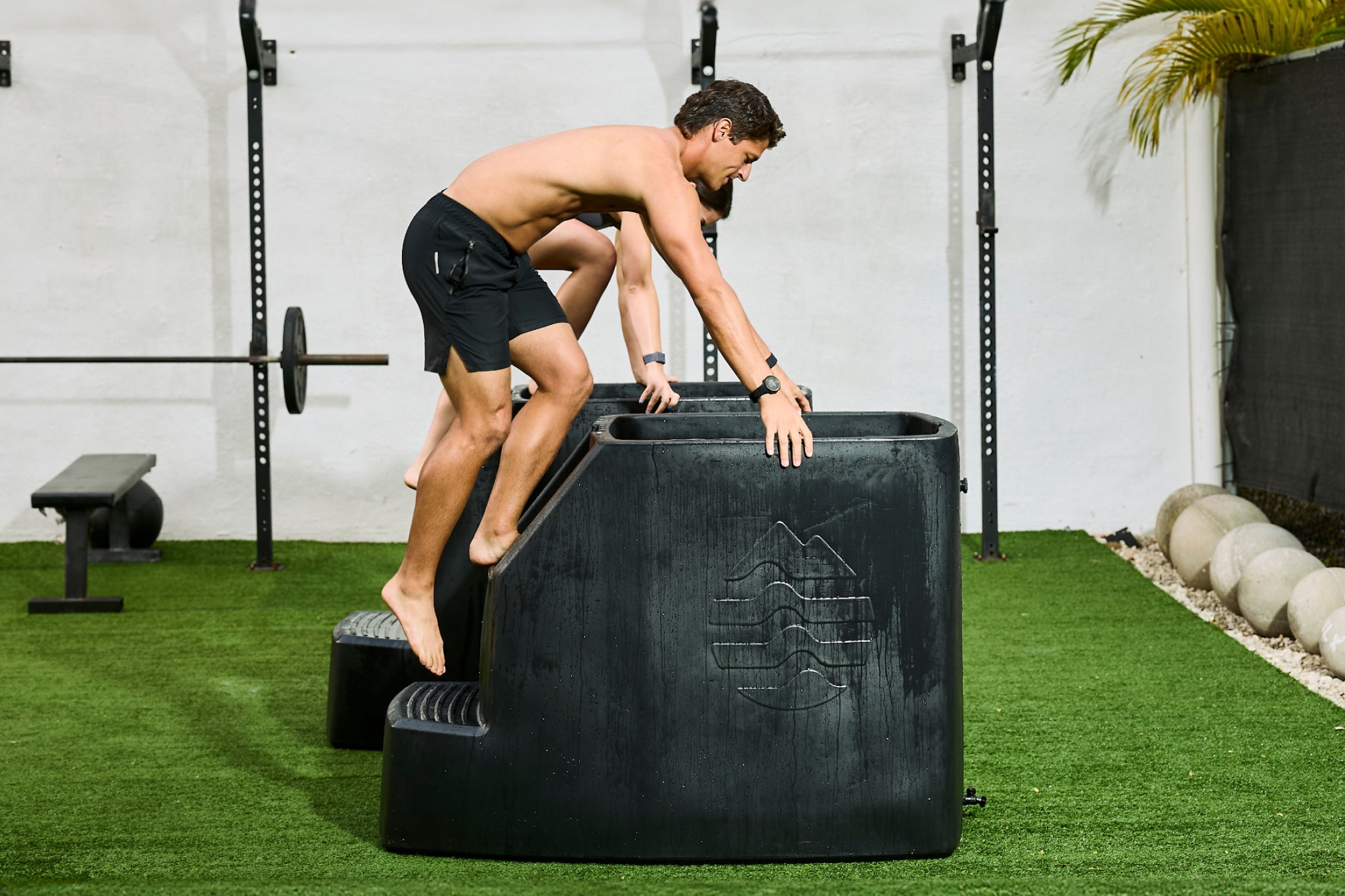 Man using Ice Barrel Cold Plunge inside indoor gym