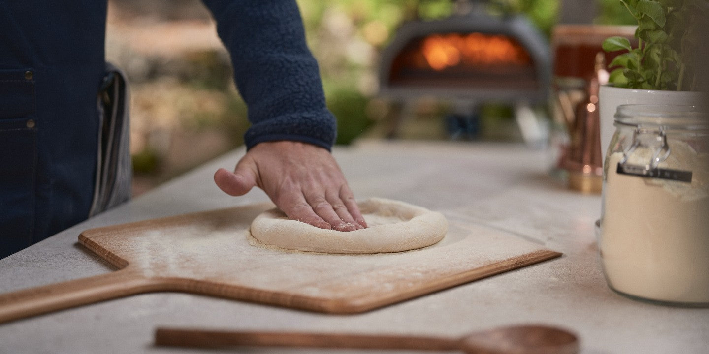 A man kneading pizza dough